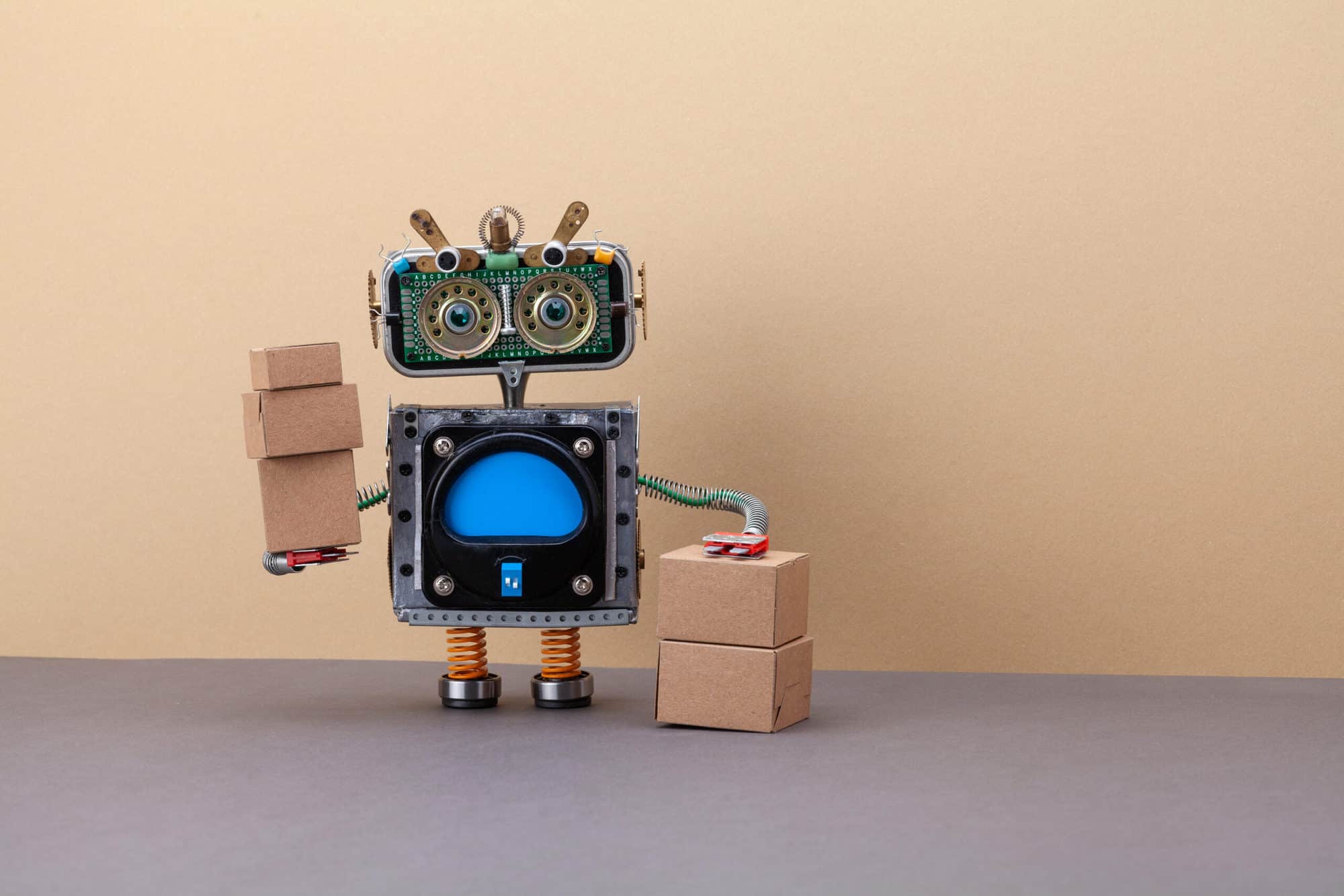 Robotics logistics and delivery service. Robot courier with parcels packed in cardboard boxes. copy space
